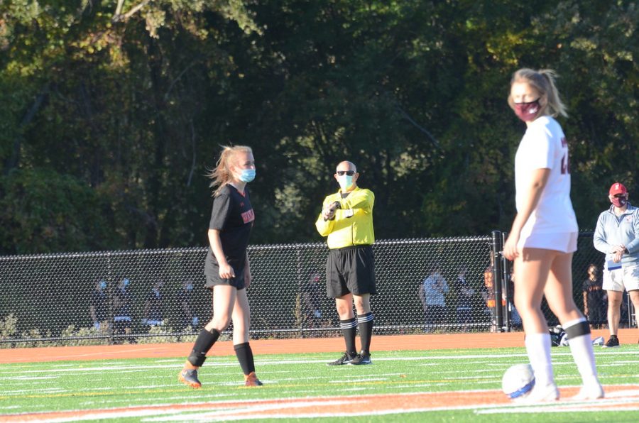 Senior captain Abby Gavron stands at half field, as she waits for the referee to blow the whistle to start the game.