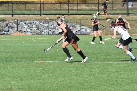 Senior captain Ella L'Esperance runs the ball down the field, ready to make a play.