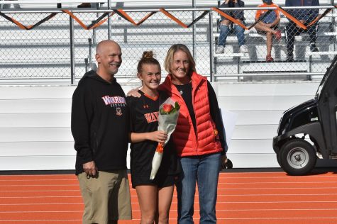 Senior captain Abby Gavron poses with her parents as she is celebrated for an extraordinary four years on the team.
