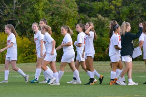 Senior Sophia Cvrk greets her teammates after a soccer game last fall. This fall, Cvrk isn't playing due to COVID-19 concerns.