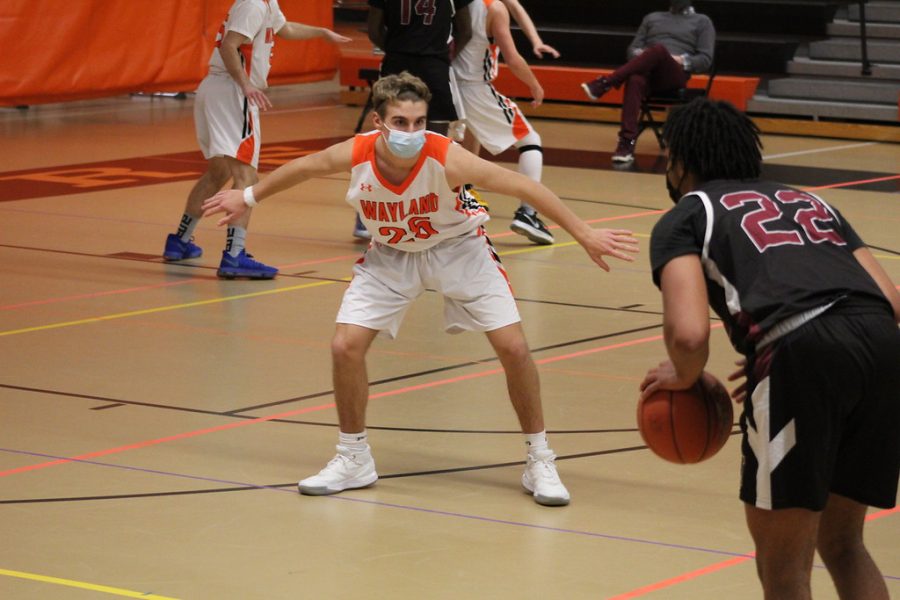 Junior Ryan MacDonald defends the net by blocking a Weston player. Wayland's defense helped them stay in the lead.
