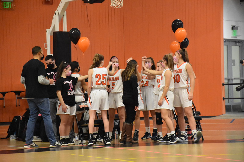Girls+varsity+basketball+head+coach+Amanda+Rukstalis+prepares+to+end+a+huddle+before+the+Warriors+game+against+Boston+Latin+on+Feb.+5th.+The+Warriors+were+unsuccessful+in+their+attempt+to+beat+the+Wolfpack%2C+but+the+impact+of+the+game+-+a+Coaches+vs.+Cancer+event+-+extended+far+beyond+the+teams+record.+It+is+about+raising+money+for+the+American+Cancer+Society+through+the+Coaches+vs.+Cancer+program%2C+Rukstalis+said.+We+have+been+doing+it+for+eight+years+now+and+each+year+%5Bthe+team%5D+has+the+initials+JG+on+their+sleeves+in+memory+of+Jim+Griffin%2C+former+Wayland+High+School+guidance+counselor+and+freshman+girls+basketball+coach.