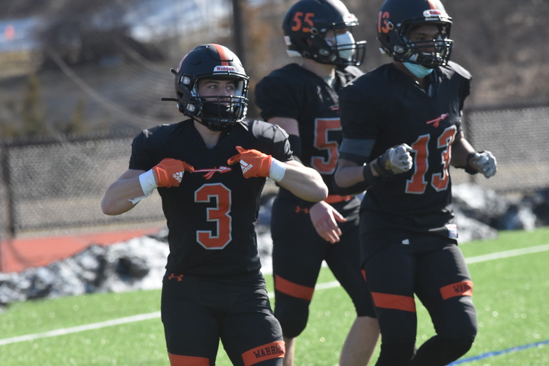 In celebration of the touchdown ran by junior running back Shayne Sutton, senior Dylan Derubeis flashes his Warrior spear. For the next fall football season, the team will be receiving new and improved jerseys, so the players cherish the last moments in this iconic black and orange attire. 