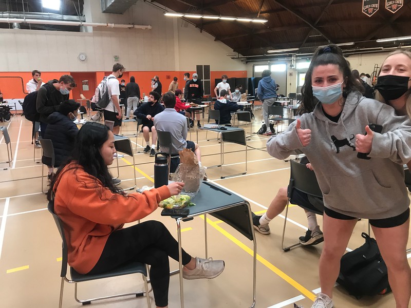 Sophomore Morgen Warner poses for a photo as students eat during second lunch. The high school implemented a third lunch to ensure there was enough space for everyone to eat at a safe distance.