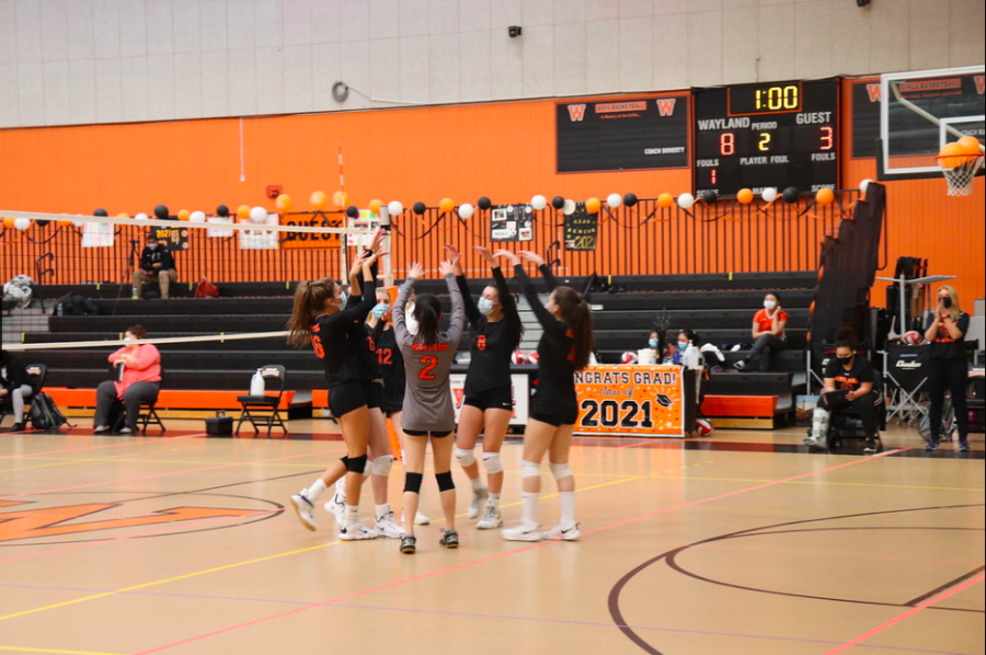 The+WHS+girls+volleyball+team+celebrates+after+winning+a+point.+This+year%2C+as+a+result+of+the+many+social+distancing+rules+imposed+on+athletic+groups%2C+the+volleyball+team+was+forced+to+modify+the+way+in+which+they+recognized+each+claimed+point.+We+found+other+ways+to+congratulate+each+other+and+make+sure+that+our+energy+as+a+team+was+high%2C+senior+captain+Mira+Ireland+said.+For+example%2C+%5Bwe+had%5D+specific+cheers+for+points+like+aces+or+kills.
