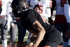 Senior football captain Nick Dresens readies himself for his opponents' next play. For the past three years, Dresens has been a largely unstoppable defensive force for the Warriors. "I see my greatest strength as being well-rounded," Dresens said. "I’m able to defend in the run game as well as drop back into pass coverage and cover receivers and running backs."