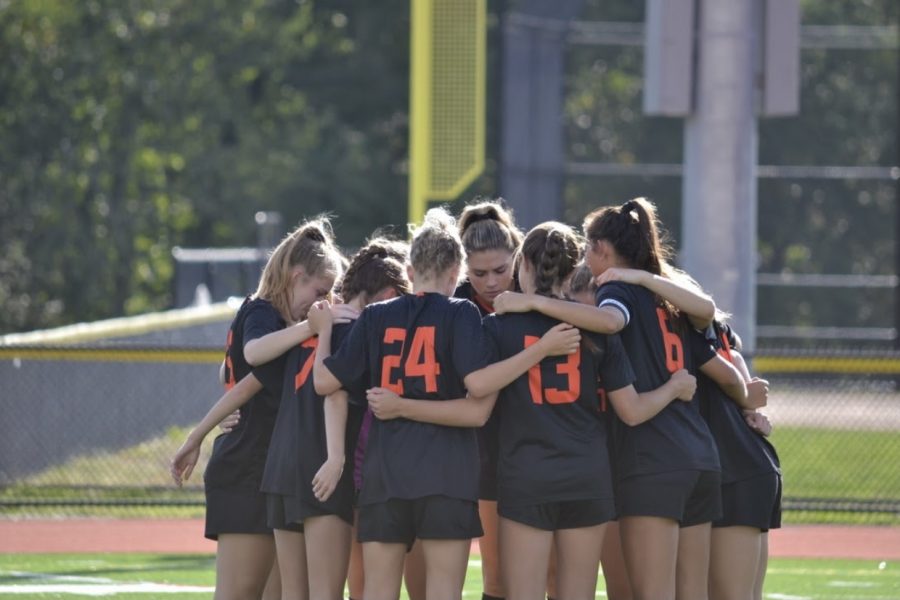 The+Wayland+girls+soccer+team+comes+together+for+a+team+huddle+before+the+game+kicks+off.+The+Warriors+look+to+carry+the+momentum+into+Thursday+against+Boston+Latin.