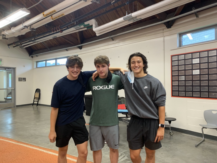 Juniors Marcos Whelton, Ethan Brandaleone and Declan Murphy gather behind their club table.  Weightlifting and Nutrition Club, which was just established this year, was swarming with students wanting to be members.