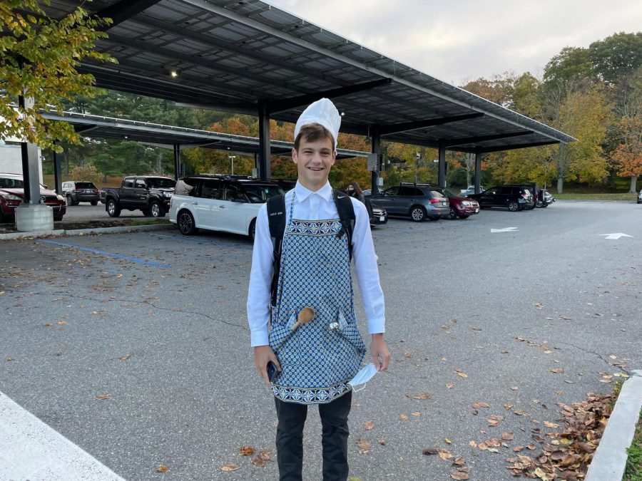 Senior Garrett Spooner displays his chef Halloween costume in the parking lot. [The costume] was very cheap, easy to get, Spooner said. The only thing I had to get was the hat, which was nice.