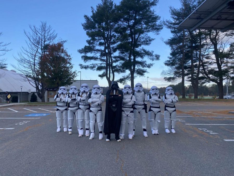From left to right: Seniors Lily Boyajian, Julia Wegerbauer, Sophie Ellenbogen, Lauren Medeiros, Sammy Johnson, Emily Staiti, Haley Melvin, Julia Raymond and Lily Boyajian assemble in their Star Wars themed costumes before they walk into school.
