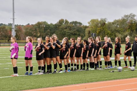 Wayland girls varsity soccer faces the flag ahead of their senior night game against Waltham. They would win 2-0, a welcome victory after losing three games in a row, which included their game against Lincoln-Sudbury.