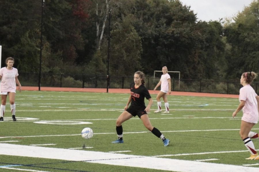 Freshman Zoe Mittelsteadt slides to get to the ball and prevent Waltham from possessing it. She has used her skills to dominate in the midfield. I feel more pressure being one of the youngest on the team because I dont want to let my team down, and I want to help them out as best I can, Mittelsteadt said.