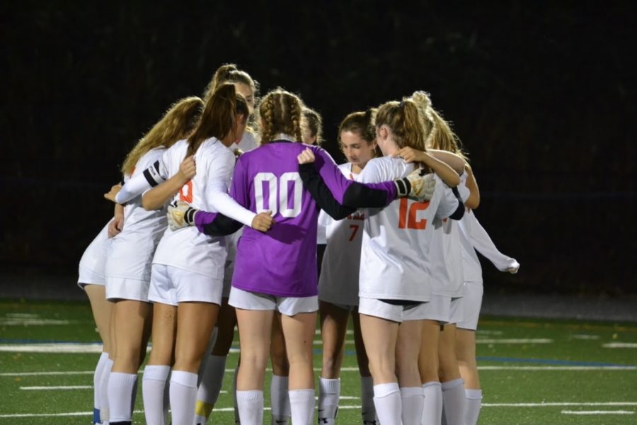 The+girls+varsity+soccer+starters+huddle+together+prior+to+the+opening+kickoff.+They+would+play+a+hard+fought+game+against+Lincoln-Sudbury%2C+but+would+fall+short+of+the+win.