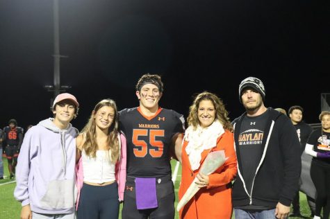 Senior captain Luciano Sebastianelli stands with his family as he is celebrated for his commitment to the Wayland football program. His two siblings also attend Wayland High School.