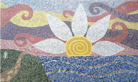 The Lauren Dunne Astley memorial mosaic at Wayland High School, which can be found in the courtyard adjoining the Commons. Designed by Astley’s close friends and teachers, the mosaic contains small details that represent Astley to them, like the Starbucks symbol hidden in the green glass on the left. “I think of Lauren often, especially when I walk past that glittering Wayland High School mosaic her friends and teacher collectively crafted in her memory,” retired WHS history teacher Kevin Delaney said during the 10 year anniversary remembrance for Astley that was held over the summer.  “As I walk through the courtyard and see that sunshine daisy radiating over a blue horizon, I remember the bright fin loving and inquisitive student arriving late to my US history class bearing a sheepish grin and an extra large coffee in hand.” This past July marks the ten year anniversary of Laurens death and the memorial funds creation.
