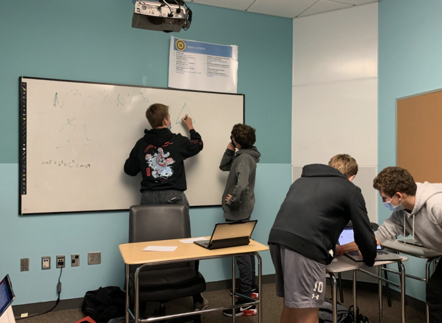Freshmen+Noah+Notargiacomo%2C+Donovan+Mason%2C+Peyton+Moran+and+Jaden+Kaufman+work+together+to+solve+a+math+problem+from+their+homework+during+study+hall.+Students+use+conference+rooms+during+their+study+halls+to+get+work+done+in+quieter+areas+with+friends.