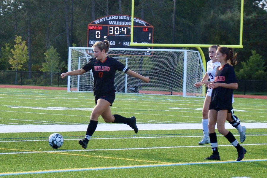Senior girls soccer captain Sophie Ellenbogen clears the ball upfield. This year, girls varsity soccer played their hearts out, ending the season with six wins.