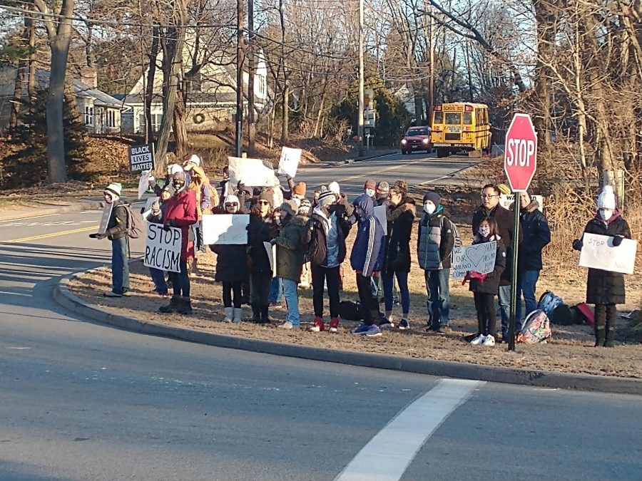 Wayland students, parents and staff congregate at the middle schools street entrance on Monday, Dec. 20.