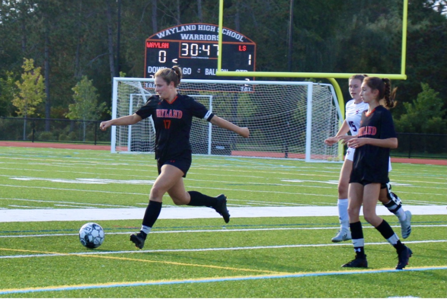 Girls soccer captain senior Sophie Ellenbogen clears the ball upfield. This year, girls varsity soccer played their hearts out, ending the season with six wins.