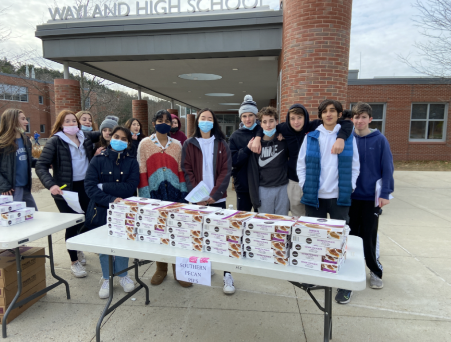 The freshman executive board stands outside of Wayland High School and hands out pies. Each pie was $18, and all profits went to the Class of 2025 for its future events. I think the fundraiser went really well,” Class of 2025 Treasurer Tara Sawrikar said. “We quadrupled how much we thought we were going to make, so it was a big success.”
 