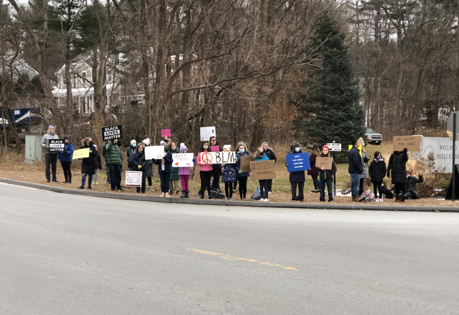 Wayland+community+members+stand+at+the+entrance+of+Wayland+Middle+School.+Many+community+members+attended+a+protest+at+WMS+Friday%2C+Dec.+10%2C+in+response+to+two+racist+incidents+that+took+place+in+the+WMS+community+this+past+week.+For+most+of+us%2C+the+super+important+thing+is+that+students+and+families+of+color+in+our+community+know+that+we+don%E2%80%99t+condone+the+actions+of+a+few%2C+WMS+parent+and+protest+organizer+Meg+Flatley+said.++%0A++
