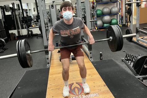 Junior Hunter Harris exercises during a Weightlifting Club meeting in the weight room. I started [Weightlifting Club] to be a friendly face in the gym and to help others that are also trying to get into lifting, Harris said.