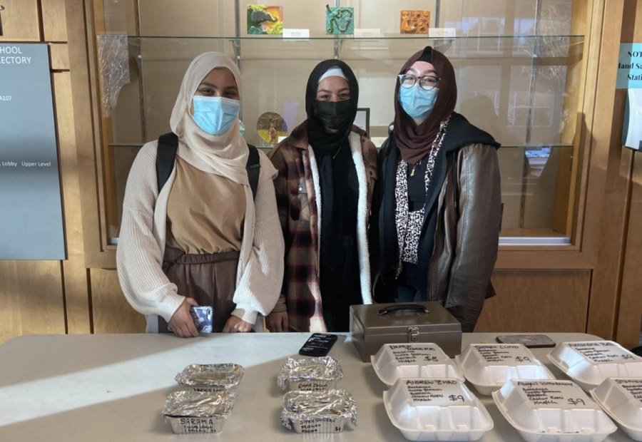 Mariam Gayed (left), Hedaia Elelimy (middle) and Noreen Javed (right) hand out containers of pre-ordered desserts. “The Muslim Student Association (MSA) is fundraising through bake sales with traditional pastries from our cultures,” Javed said.