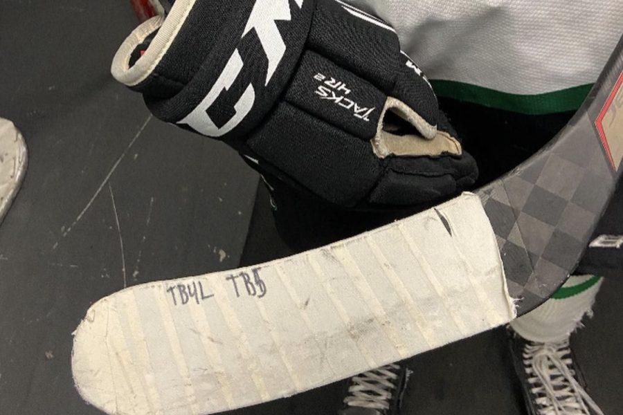 Sophomore Sam Brandes stick reads TB4L and TB5, or Teddy Balkin for Life and Teddy Balkin 5. Teddy Balkin tragically passed away playing hockey on Thursday, Jan. 6. Brande is also honoring Balkin off the ice with a petition for USA Hockey to mandate neck guards. I wrote his initials and number on my stick, Brande said. [Balkin] was super selfless, he would rather see you succeed than succeed himself.