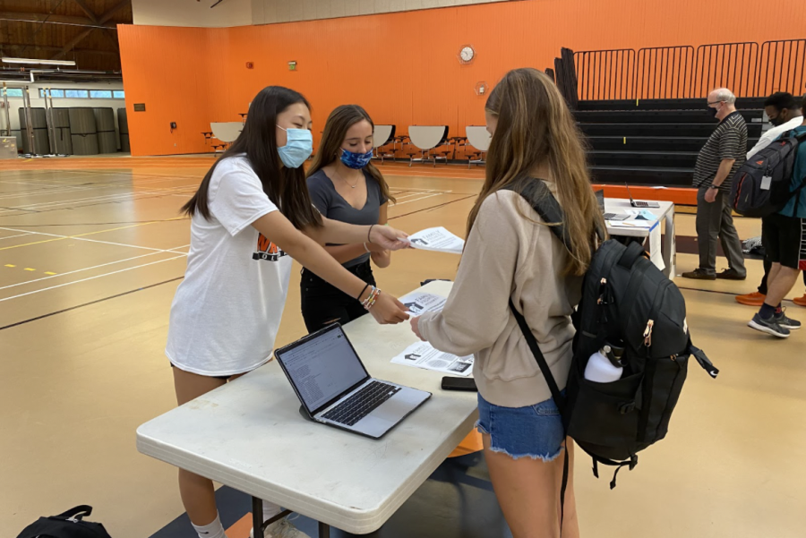 Family Promise Club leaders Maeve Myles and Elena Liu hand out flyers to promote their club during the Wayland High School Club Fair. They also utilize other ways to spread the word about Family Promise. “We have social media and an Instagram to get the word out about Family Promise,” Liu said. “[Our social media platforms are] a space where we post a lot about the issue of homelessness and where we also repost the Family Promise Organization’s Instagram.”