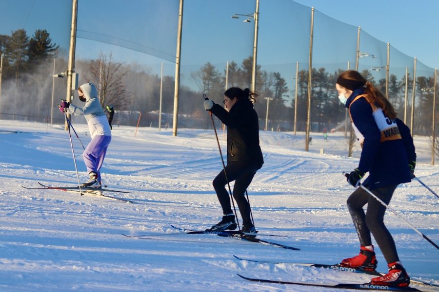 Seniors Jenna Garber, Nadia Calder and senior captain Silvija Grava ski uphill. The WHS Nordic ski team mainly skate skis, but occasionally classic skis for the Massachusetts Eastern High Schools race.