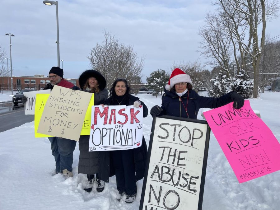 Protestors assemble outside Wayland High School the morning of Monday, Feb. 14.  We feel that everyone should be able to make their own choice and decide what is medically best for them,  one anonymous protestor said. 