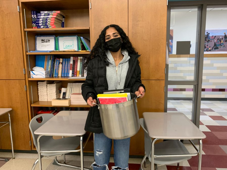 Freshman Katelyn Chirayath poses with a pot which is holding all the stuff she needs for school. My friend came up with the idea, and I just went along with it. Chirayath said.