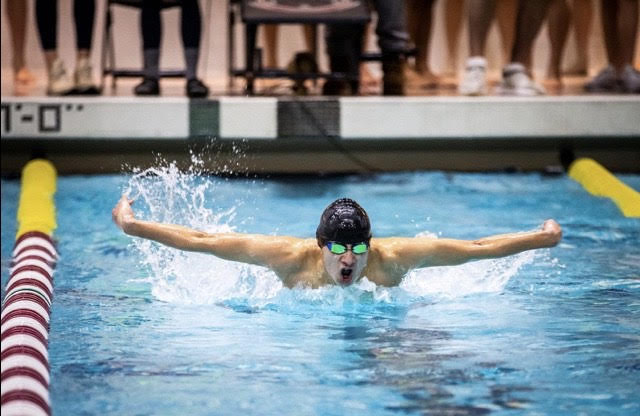 Senior+Lucas+Pralle+emerges+from+the+water+to+take+a+breath+during+his+100+meter+butterfly+event+at+states.+Pralle+came+in+first+place+at+states+in+his+event.+It+feels+amazing+to+be+a+part+of+a+team+that+has+performed+as+well+as+we+have%2C+Pralle+said.+Everyone+puts+in+the+work+in+practice+and+our+coaches+work+tirelessly+to+train+and+guide+us+to+be+the+best+swimmers+we+can+be.