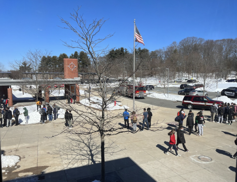 Students gather outside in the courtyard while firemen search the North Building after an unexpected fire alarm. This was the third time that the fire alarm went off this week. 