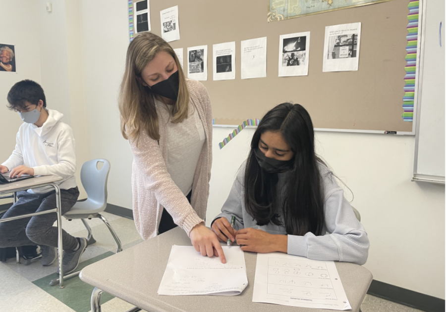 Math teacher Jacy Anzalone helps a student with their work during class. Students need help at all different levels, so I just try to keep doing that, Anzalone said. 