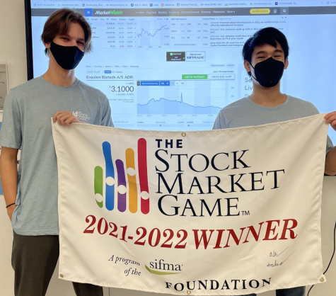 Juniors Alexei Rjanikov (left) and Josh Liu (right) hold up the banner they received for winning first place SIFMAs annual Stock Market Game. The duo competed in the tournament as Siligroup Banking and ended the tournament in over $240,000 in equity. I learned how the market moves, and how to look at that and how to essentially play the game, Liu said. 