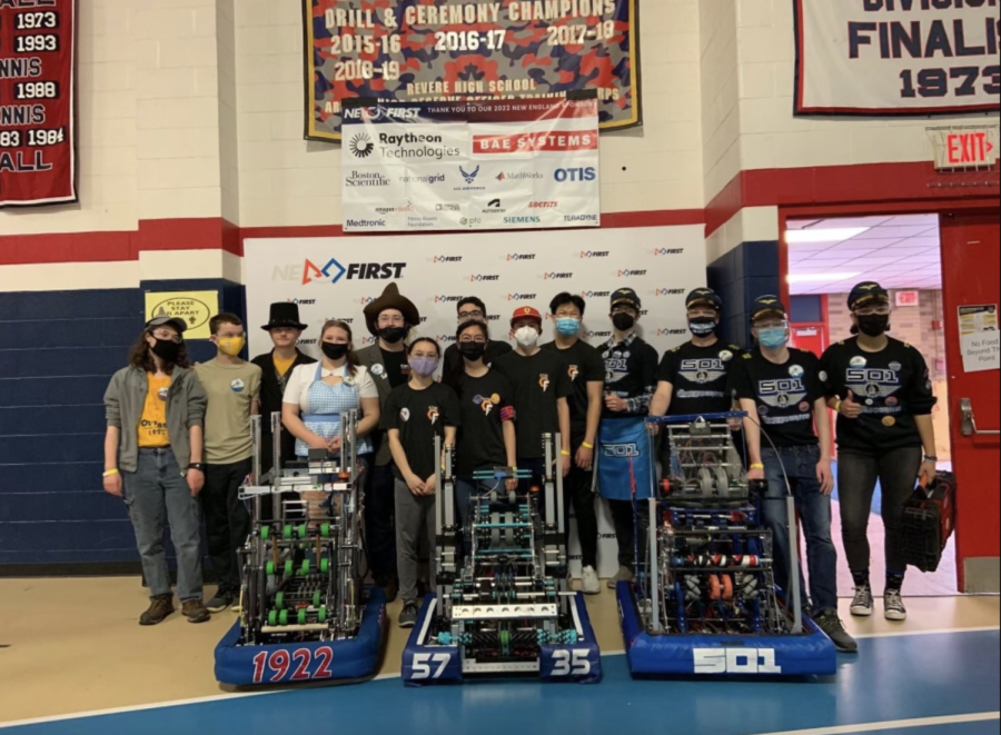 The robotics team poses in front of their robots at one of their competitions. Despite the COVID-19 pandemic, the team is making the most out of their season and have qualified for districts. “I think STEM is really important to the future, and I also think that you can learn some very valuable life skills through robotics,” junior Bella Thoen said.     
