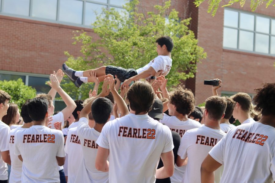 Senior Seabert Wang is lifted into the air by his peers.