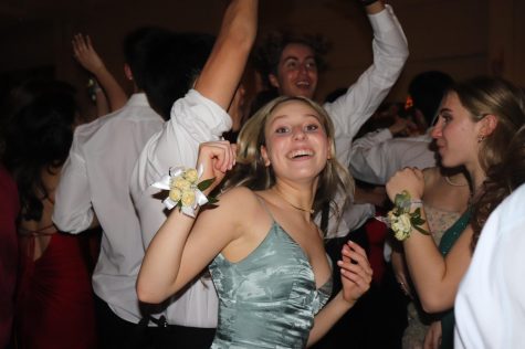 Senior Sammy Janoff jumps for joy, dancing with her friend Lily Noyes.