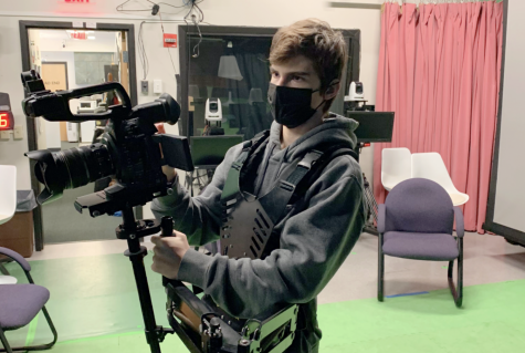 Sophomore Brendan Hines prepares a camera in the WayCAM studio before going out for a shoot. Hines is part of the Script-to-Screen class where students can make a movie and go through all steps of the process.

