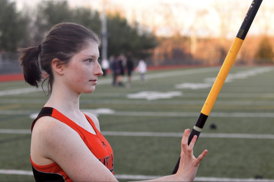 Sophomore Elena Mente prepares before pole vaulting for the Wayland high school track team. My favorite thing to do is pole vault, Mente said. I love getting to meet all new people from it.
