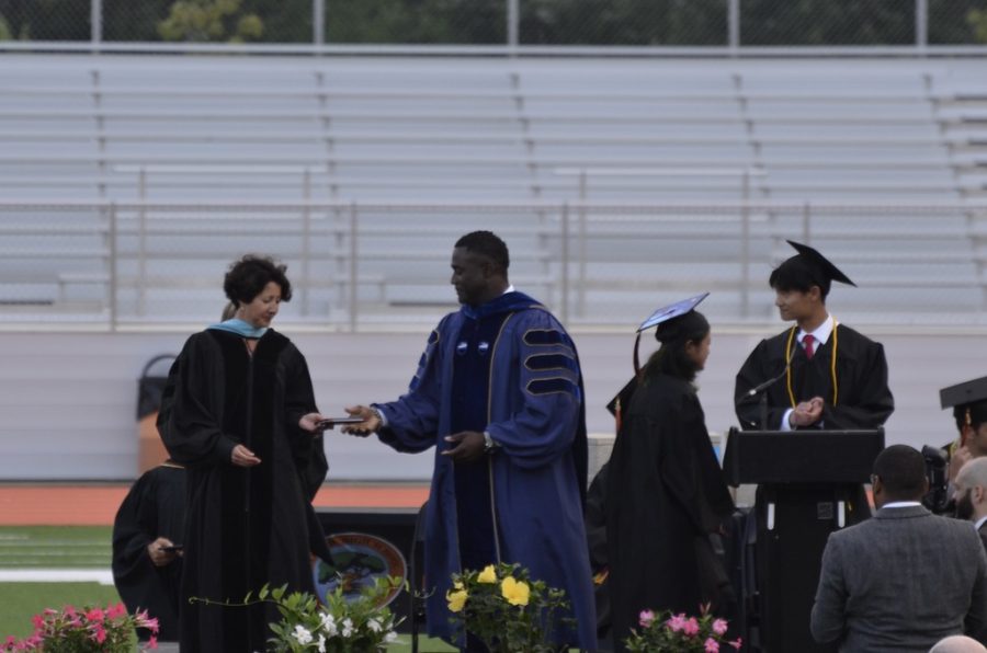 Diplomas made their way to students through a makeshift assembly line where Superintendent Omar Easy received them from one of the two class of 2022 advisers, Jennifer Reed and Scott Parseghian. Easy would then pass the diploma to Principal Allyson Mizoguchi who would hand them to the next graduating senior.