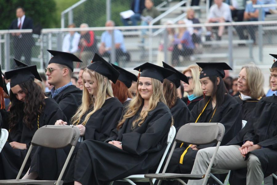 While Superintendent Omar Easy gives his speech, students listen. Senior Ella Perryman sits with other students with last names close to hers in the alphabet.