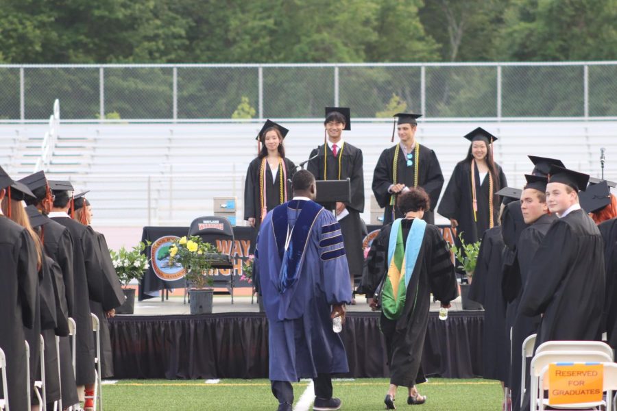 The class of 2022 officers take their positions on the podium as they watch Superintendent Omar Easy and Principal Allyson Mizoguchi walk down the aisle of graduates. Class president Andrew Zhao gave his speech after everyone took their places on the field.