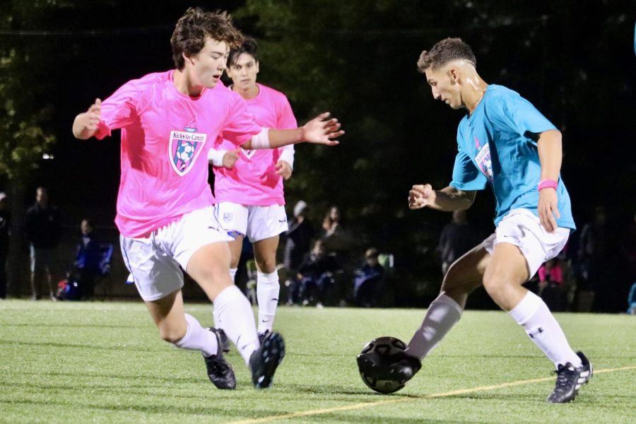 Junior Xande Santos dribbles the ball around his defenders. So far, Santos has scored three goals for the Warriors this season.  On my back, I put Protopapa which is my grandfather, Santos said.