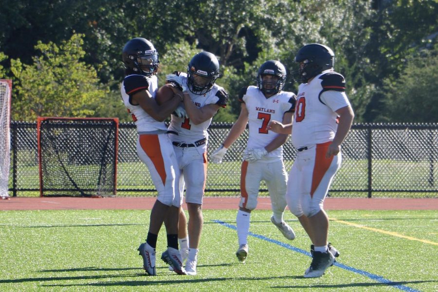 Players celebrate after junior Mehki Walker gets the first touchdown of the season.