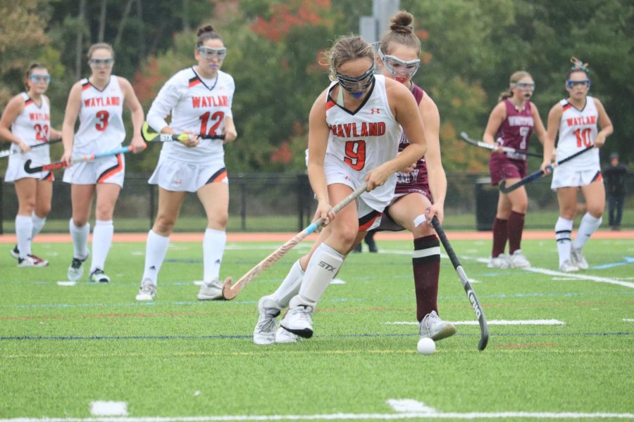 Senior Sophie Stowell challenges the Westford Academy player and hustles to get the ball.