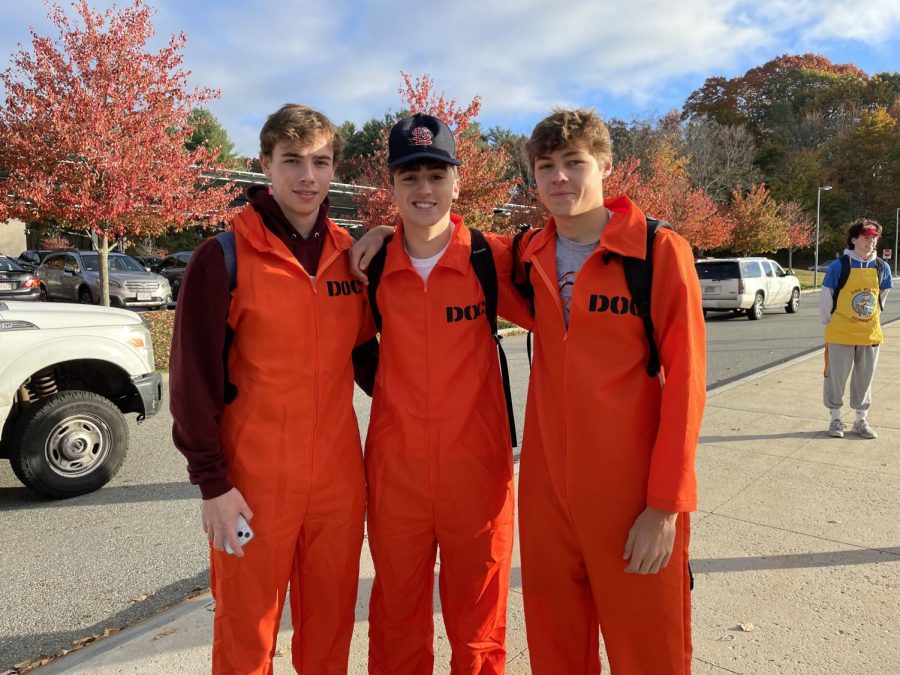 Seniors Chris Merullo, Noah Malkin and Fred Czauderna stand in front of the parking lot in their inmate costumes on their way into school. We wanted to do a costume all together and this was the only thing we could agree on, Merullo said.