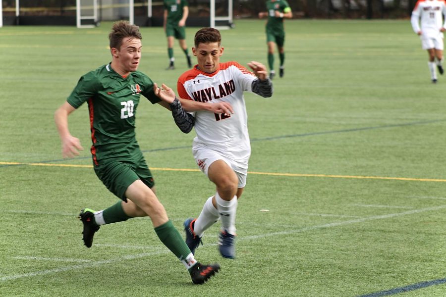 Junior Xande Santos runs alongside a Hopkinton player, attempting to get to the ball first. Next season, we have a lot of returners, so I think we will be a strong team, Santos said. Im looking forward to it.