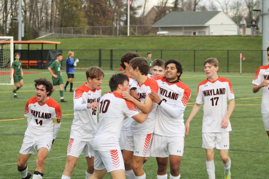 After scoring Waylands second goal of the game, senior Fred Czauderna celebrates with his teammates. The team scored two goals during the game, shot by Czauderna and senior captain Luke Caples.